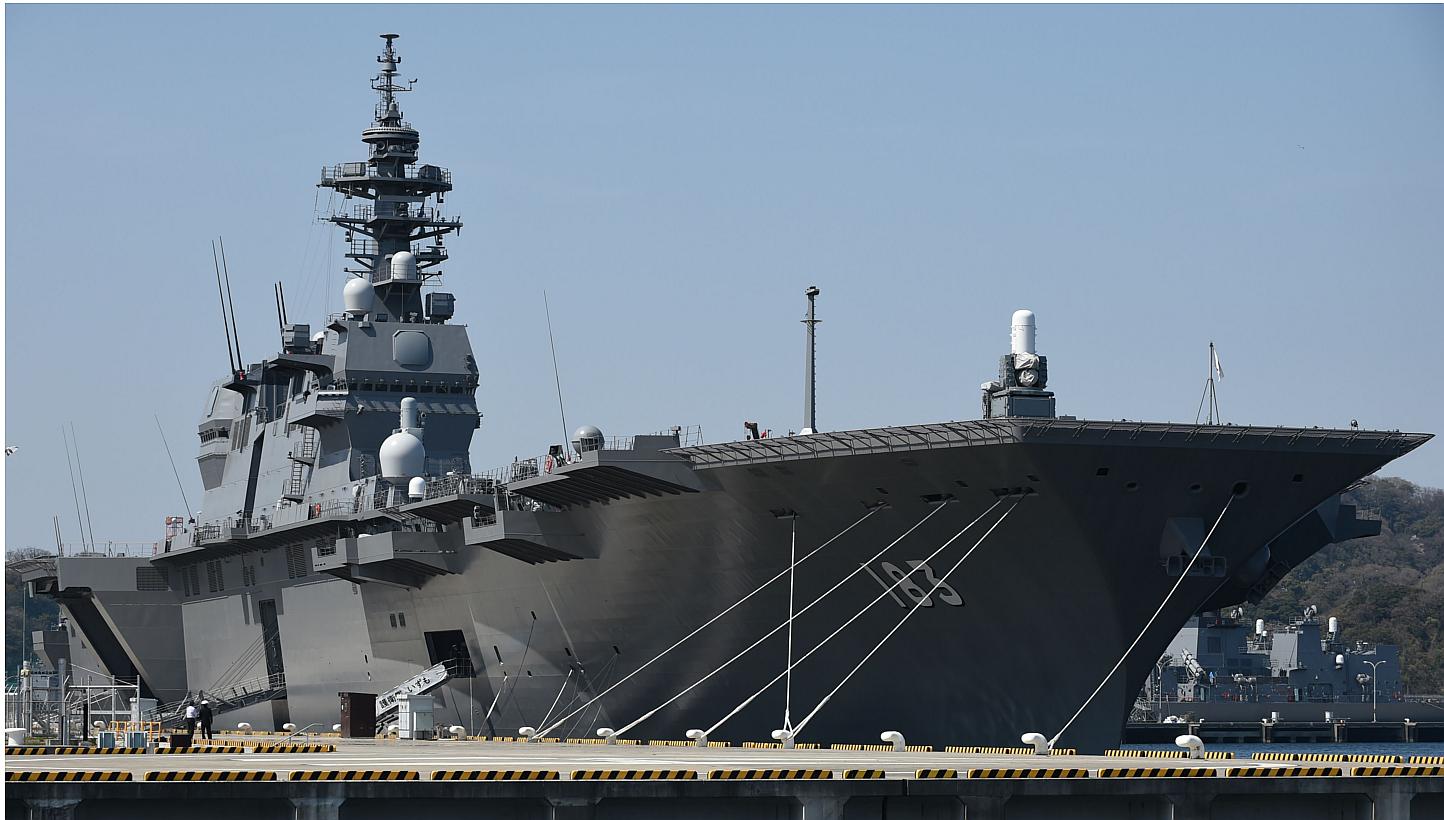 The Japan Maritime Self Defence Force helicopter destroyer Izumo sits at anchor at Yokosuka base in Yokosuka on March 31, 2015.&nbsp;Japanese ruling party officials signed off on bills on Monday, May 11, to implement a drastic change in security poli
