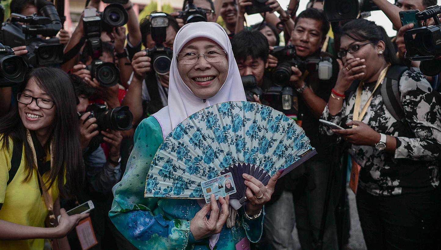 Parti Keadilan Rakyat (PKR) president&nbsp;Wan Azizah Wan Ismail&nbsp;(centre), wife of Malaysian opposition leader Anwar Ibrahim, arrives at a polling station during a by-election in Permatang Pauh, in the northern Malaysian state of Penang on March