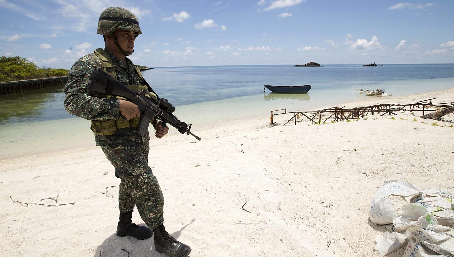 A Filipino soldier patrols at the shore of Pagasa island (Thitu Island) in the Spratly group of islands in the South China Sea, west of Palawan, Philippines on May 11, 2015. -- PHOTO: EPA&nbsp;