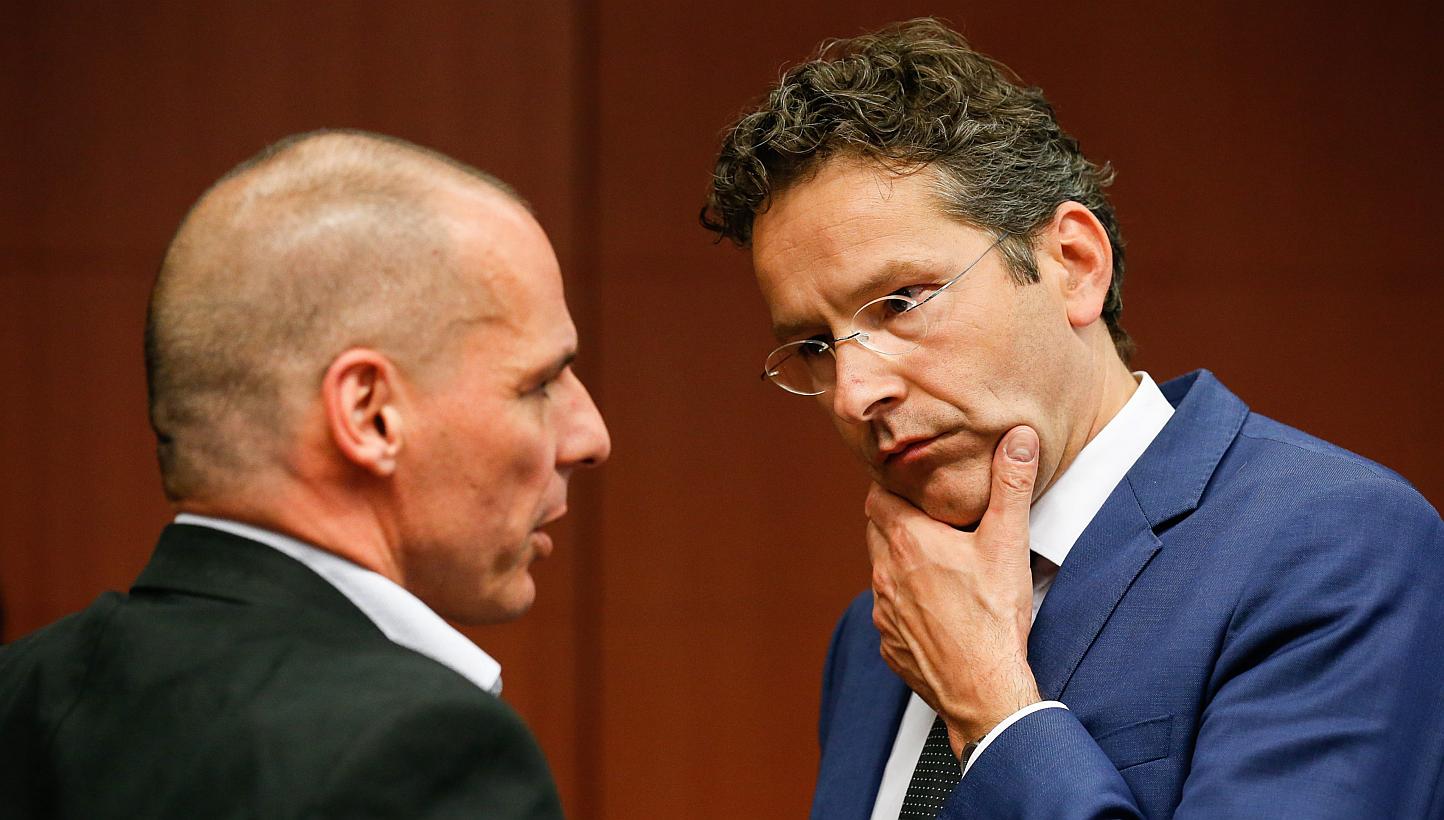 Greek Finance Minister Yanis Varoufakis (left) and Eurogroup president Jeroen Dijsselbloem talk during the Eurogroup meeting of Finance ministers at the EU council headquarters in Brussels, Belgium, on May 11, 2015. -- PHOTO: EPA