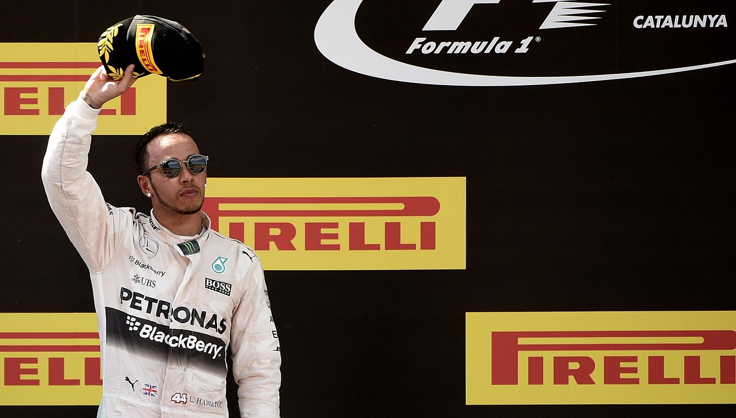 Mercedes AMG Petronas F1 Team's Lewis Hamilton celebrates on the podium after the Spanish Formula One Grand Prix on May 10, 2015 at the Circuit de Catalunya in Montmelo on the outskirts of Barcelona. The British driver's long-awaited new deal with Me