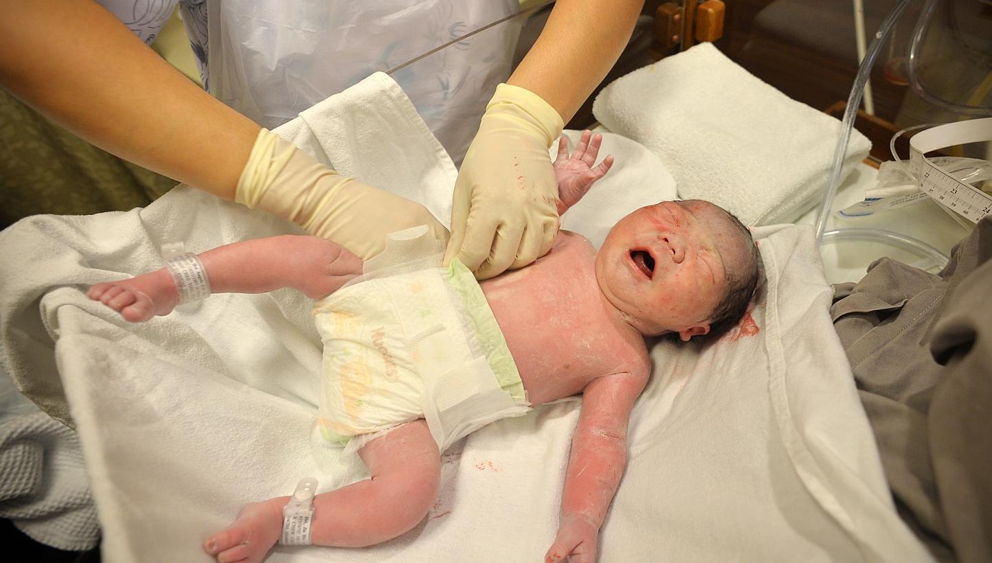 A newborn baby gets changed into a diaper at the hospital. -- PHOTO: SPH