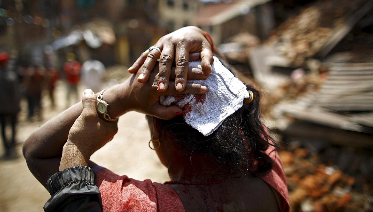 A woman injured in an earthquake walks toward a hospital soon after the earthquake in Sankhu on May 12, 2015. -- PHOTO: REUTERS