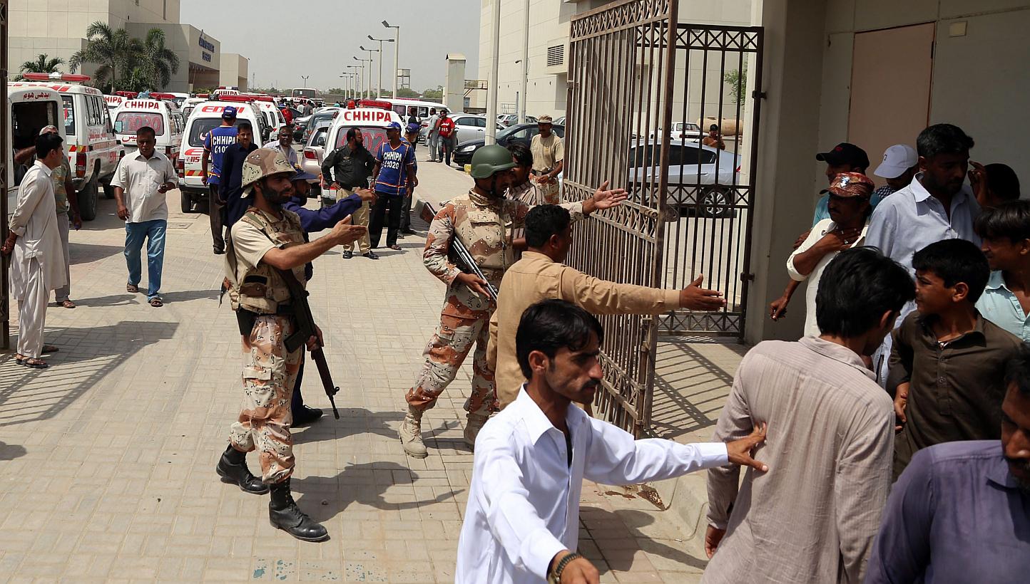 Pakistani rangers stand guard outside a hospital where injured victims of target killing are brought to hospital in Karachi, Pakistan on May 13, 2015. The Islamic State in iraq and Syria (ISIS) claimed responsibility for the attack that killed at lea