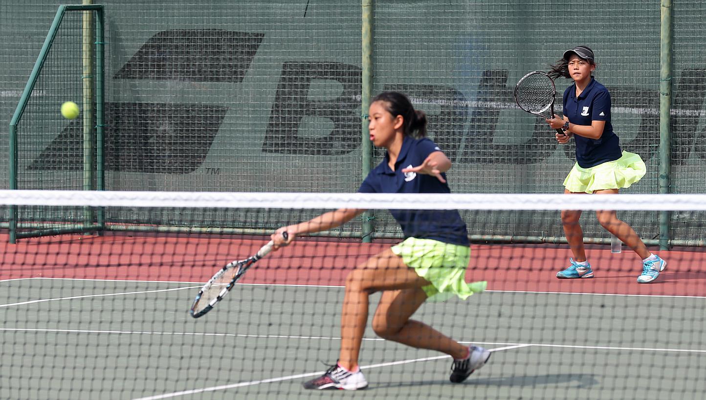 Rachel Wong (left) and Hilary Tan (right), in the Doubles match of the National A Division Tennis finals (Girls) between Anglo-Chinese Junior College and Raffles Institution, at Yio Chu Kang Tennis Centre on May 13, 2015. -- ST PHOTO: SEAH KWANG PENG
