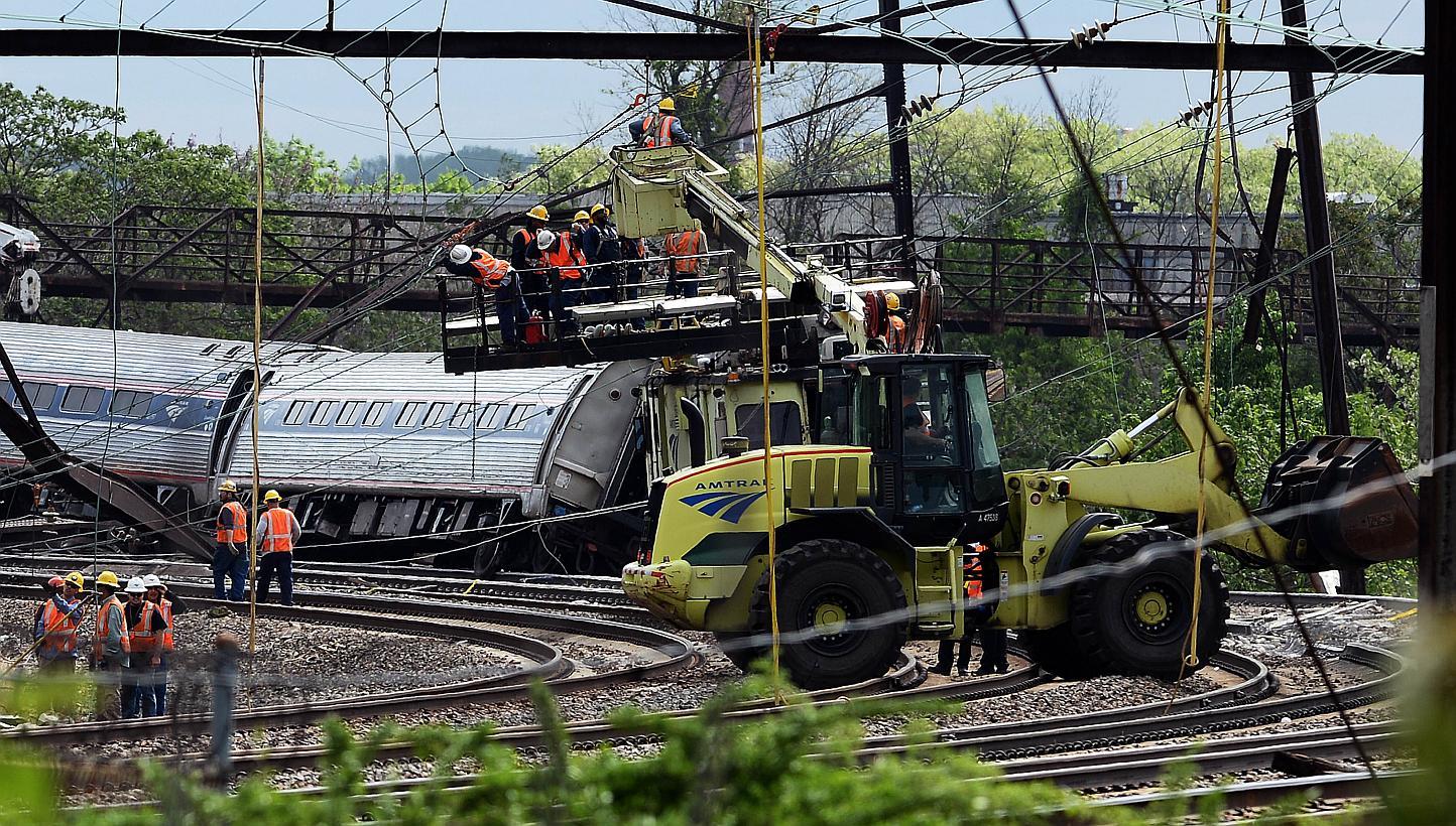 Rescuers work around the derailed carriages of an Amtrak train in Philadelphia, Pennsylvania, on May 13, 2015. -- PHOTO: AFP 