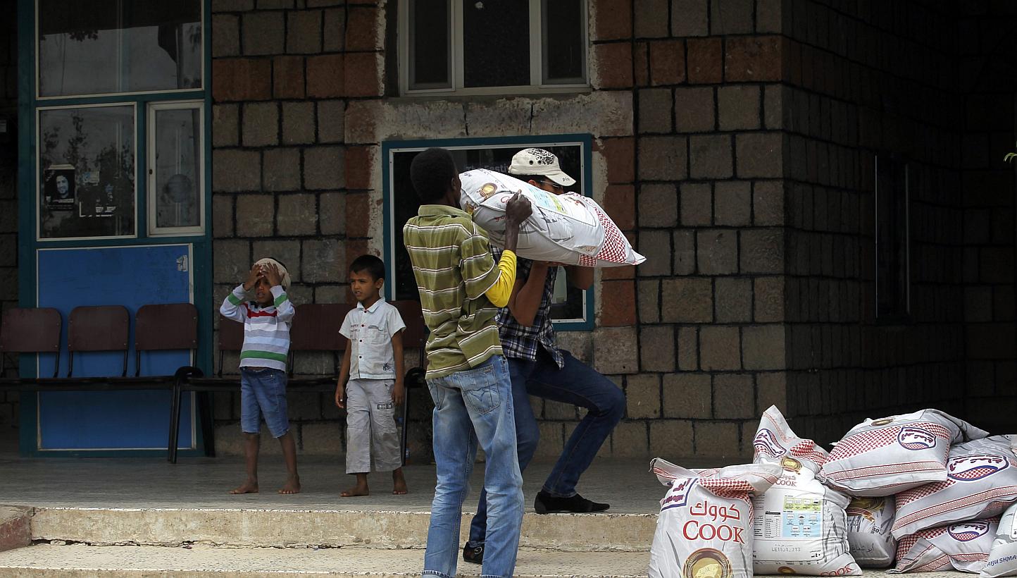 Volunteers carry aid provided for Yemenis affected by ongoing air-strikes carried out by the Saudi-led coalition inside a gymnasium turned into a temporary evacuation center in Sana'a, Yemen on May 3, 2015. A senior Iranian commander said it was Iran