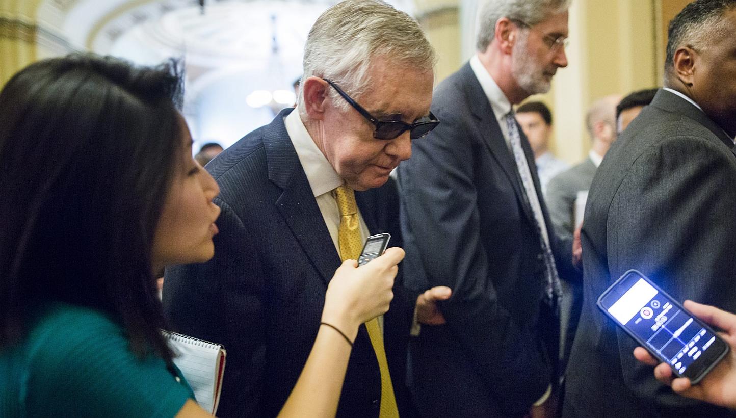 US Senate Minority Leader Democrat Harry Reid from Nevada walks to the Senate floor for a procedural vote on a much-debated trade bill in the US Capitol in Washington, DC, on Tuesday. The bill, which failed to progress in the Senate, would have given