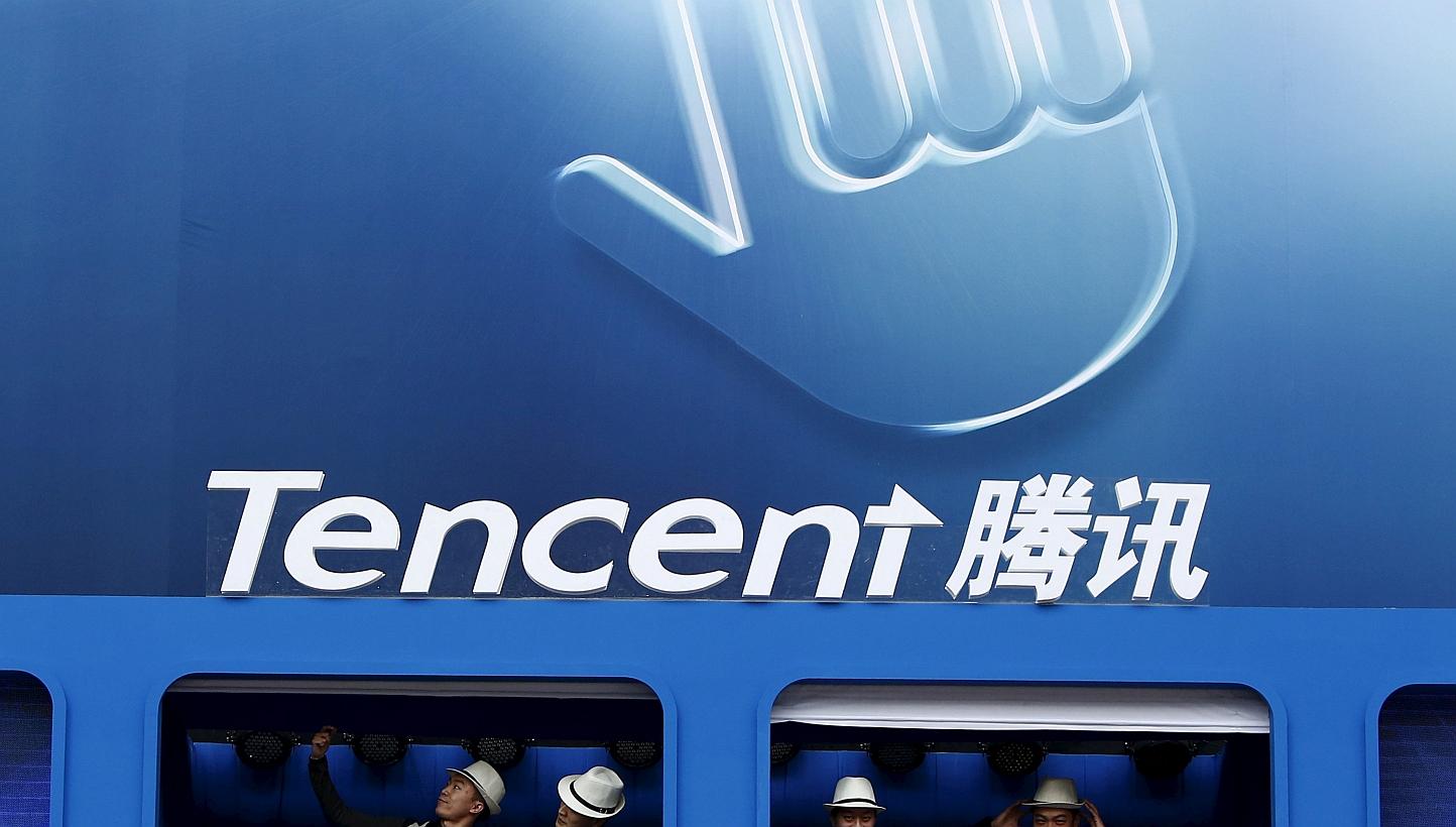 Dancers perform underneath the logo of Tencent at the Global Mobile Internet Conference in Beijing in a May 6, 2014 file photo. - PHOTO: REUTERS