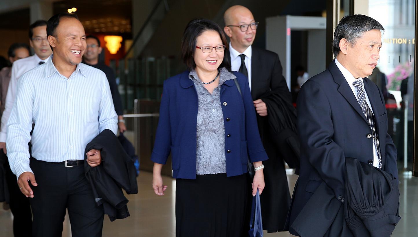 Workers’ Party and AHPETC chairman Sylvia Lim (centre in blue) with fellow Aljunied GRC MP Muhammad Faisal Abdul Manap (left) outside the Supreme Court on May 5, 2015. -- ST PHOTO: WONG KWAI CHOW