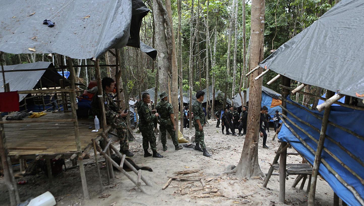 Thai soldiers securing an abandoned jungle camp believed to have been used by human traffickers to detain Rohingya migrants at a mountain in Sadao, Songkhla province, southern Thailand, on May 12, 2015. Thai police have stepped up a manhunt for the a