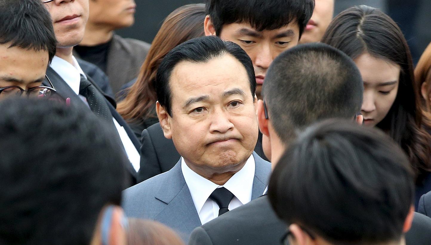 South Korean Prime Minister Lee Wan Koo (centre) surrounded by relatives of the victims of the Sewol ferry disaster, at the official memorial altar in Ansan on the first anniversary of the tragedy, April 16, 2015. Mr Lee was questioned by prosecutors