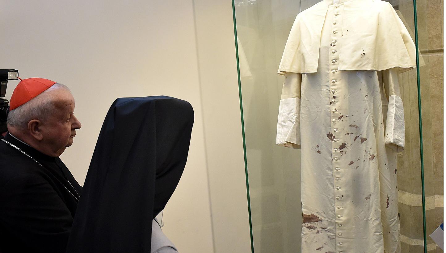 Cardinal Stanislaw Dziwisz (left) and nun Tobiana (second left), who took care of the pope, view the late Pope John Paul II's bloodied cassock in Krakow, Poland, on May 13, 2015. -- PHOTO: AFP&nbsp;