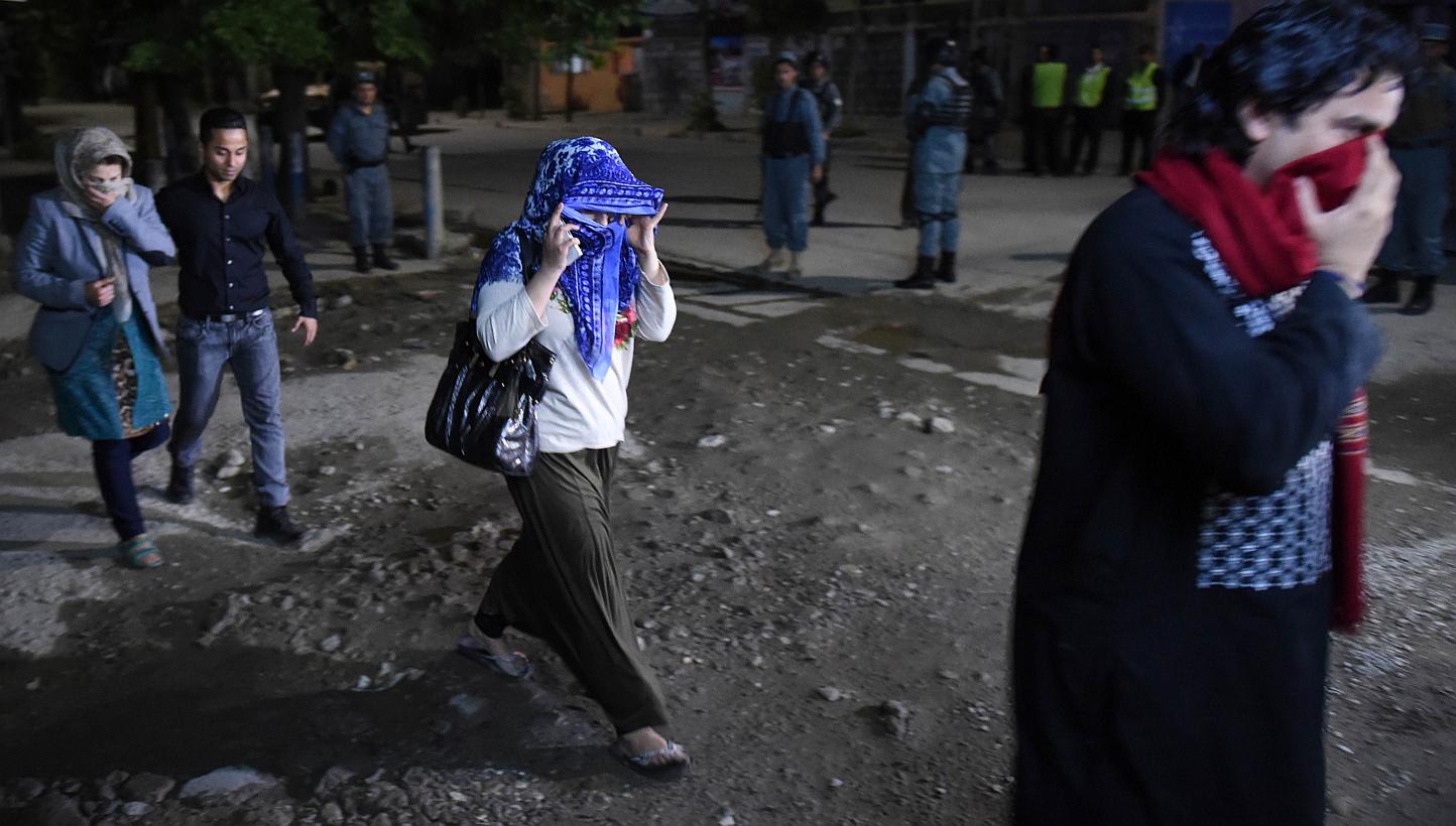 Afghan guests who were stuck inside a Kabul guesthouse walk after they were rescued by the security forces on May 13, 2015. -- PHOTO: AFP