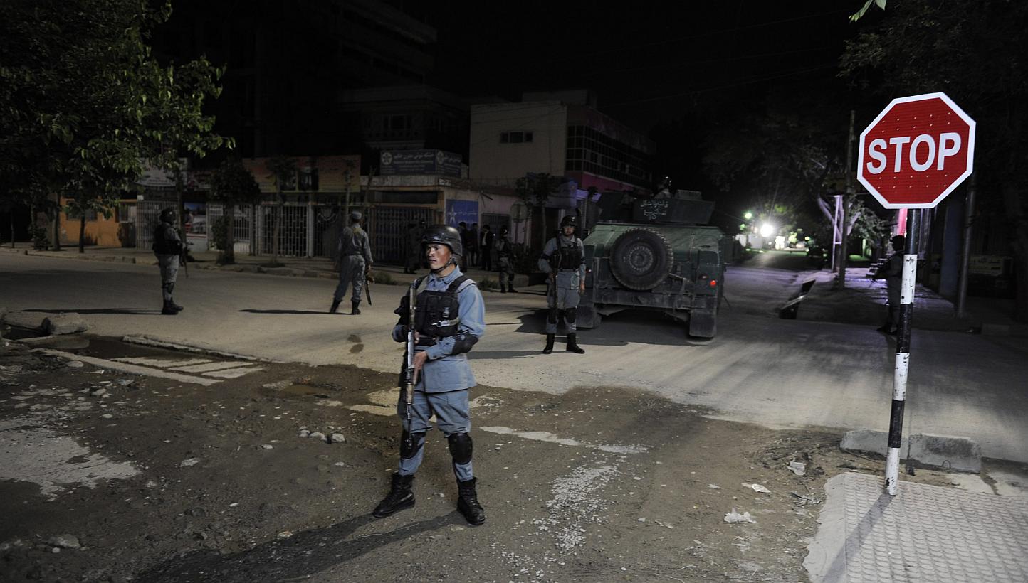 Afghan security officials secure the scene of a gunfight between militants and Government forces near a guest house in Kabul, Afghanistan on May 13, 2015. -- PHOTO: EPA