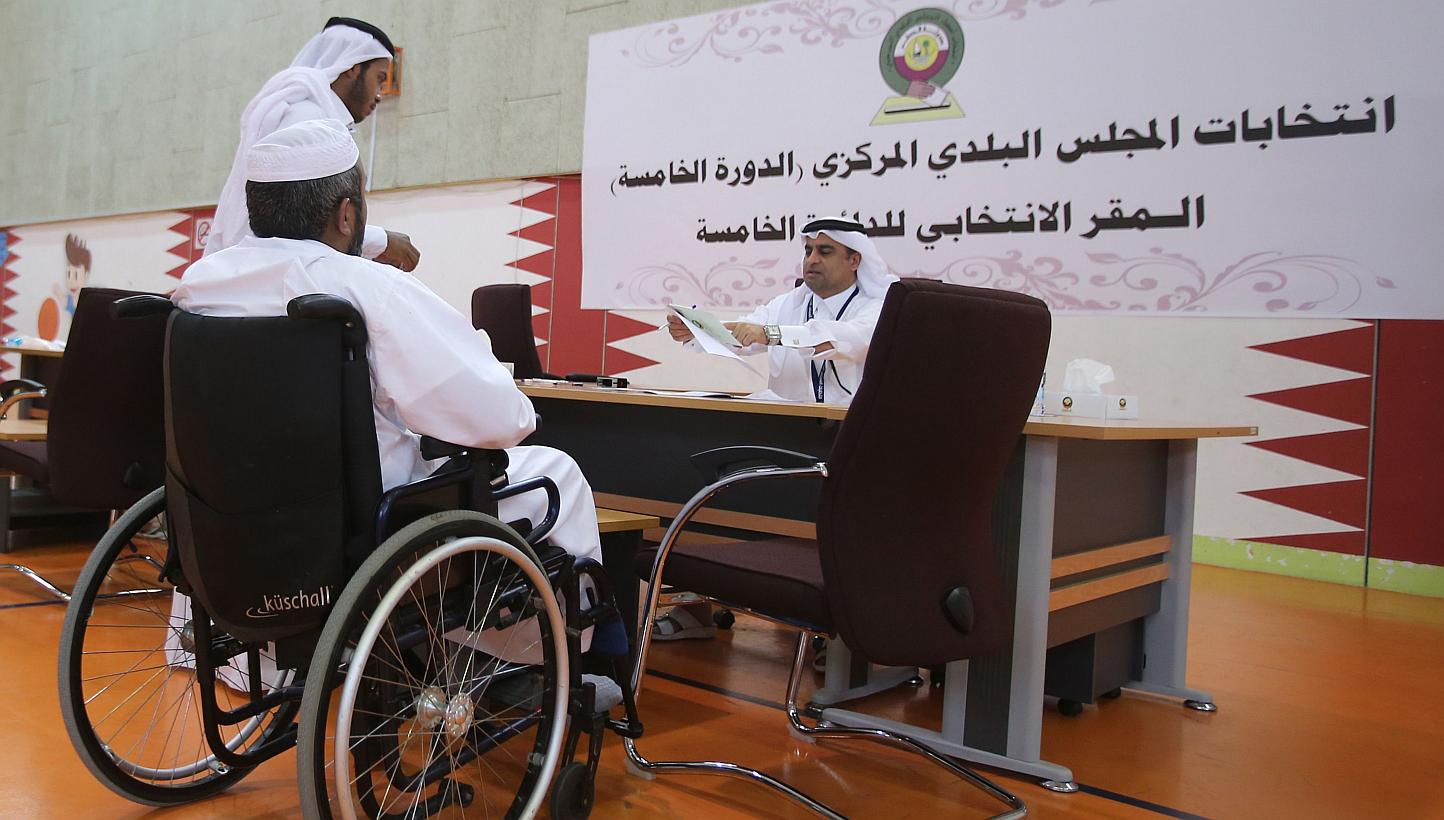 A Qatari man casts his vote for municipal elections at a polling station in Doha, on May 13, 2015. Two women were voted onto the emirate's only directly elected body, the Central Municipal Council, officials announced on Thursday, May 14, a first for