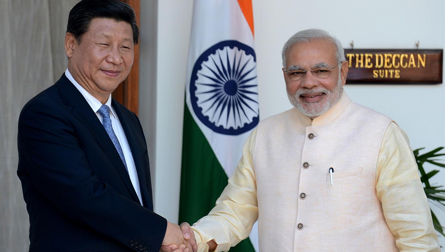A&nbsp;September 2014 photo shows Indian Prime Minister Narendra Modi (right) shaking hands with Chinese President Xi Jinping during a meeting in New Delhi.&nbsp;Modi on Wednesday left for China on an official visit focused on boosting trade ties bet