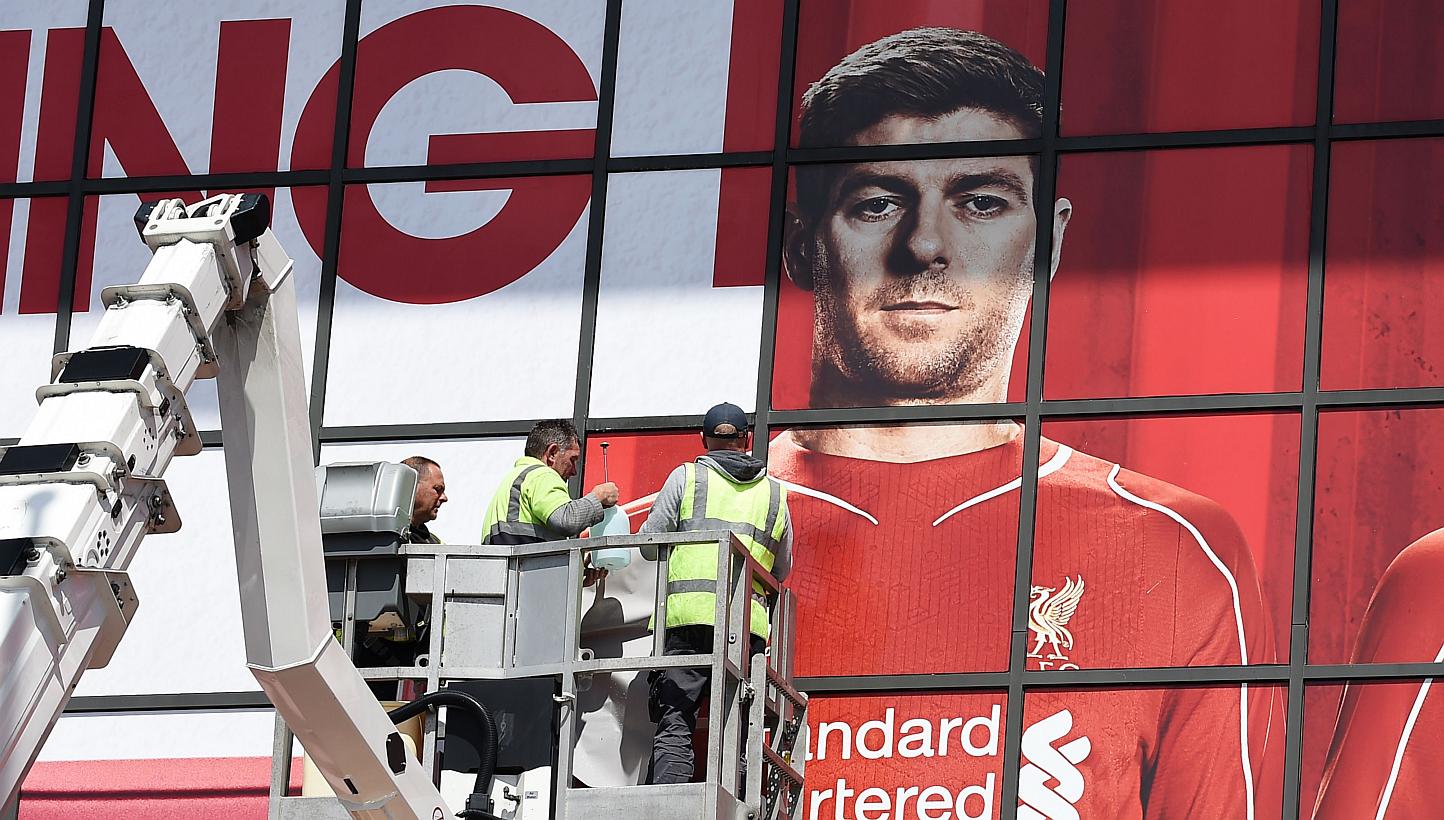 Workmen work on a poster of Liverpool's English midfielder Steven Gerrard outside The Kop stand at Anfield, Liverpool, on May 13, 2015.&nbsp;Tickets to &nbsp;the game, Gerrard's final home appearance, which usually cost 47 pounds (S$98),&nbsp;are on 