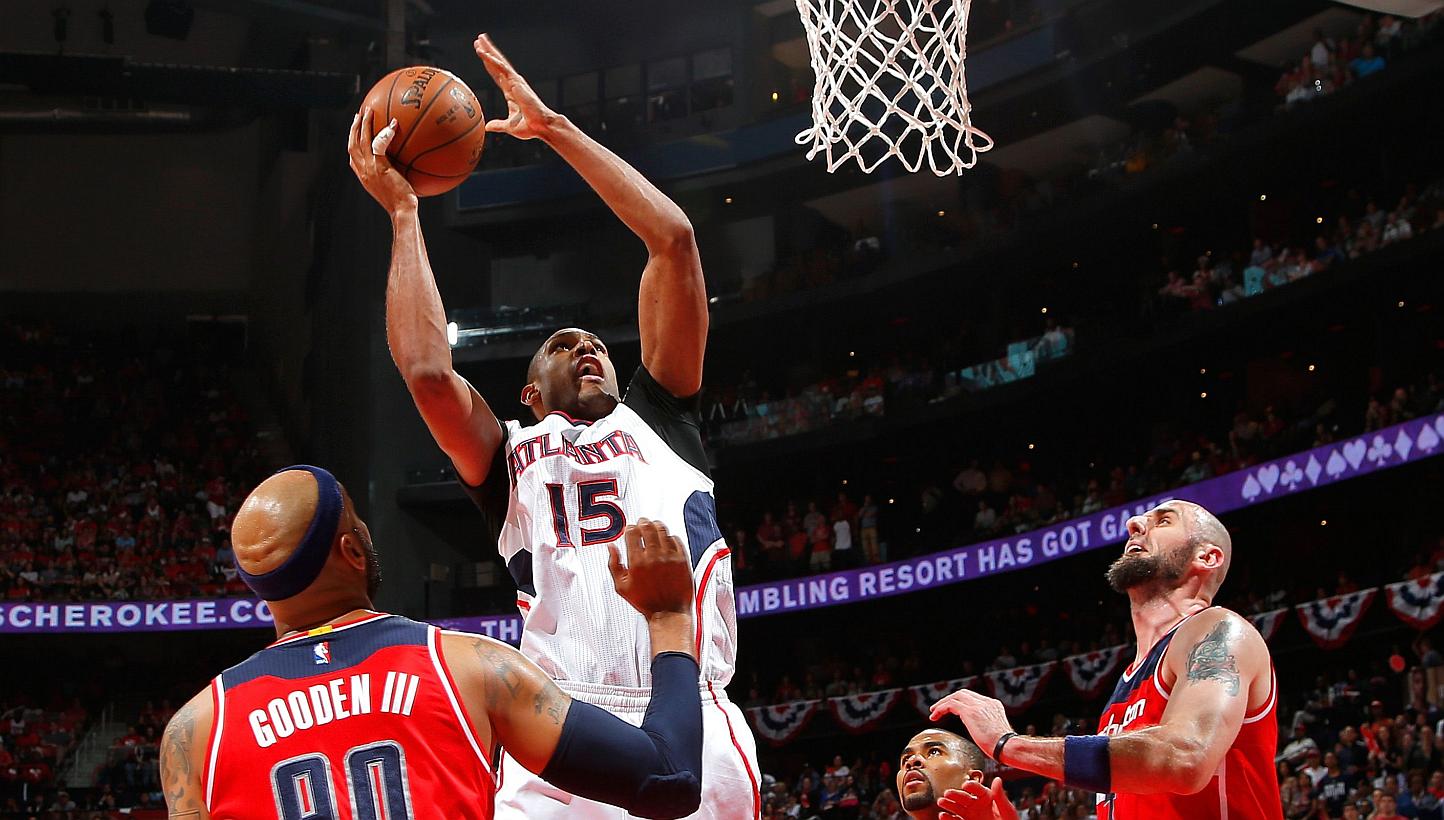 Al Horford #15 of the Atlanta Hawks shoots over (from left) Drew Gooden #90, Ramon Sessions #7, and Marcin Gortat #4 of the Washington Wizards during Game Five of the Eastern Conference Semifinals of the 2015 NBA Playoffs at Philips Arena on May 13,