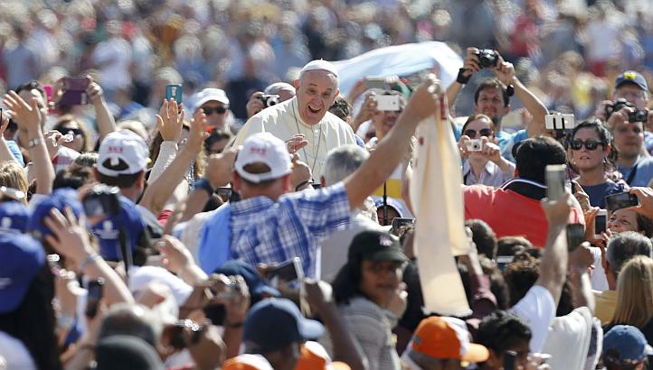 Pope Francis waves as he arrives to lead his weekly audience in St Peter's Square, at the Vatican City, May 13, 2015. The Vatican concluded its first treaty that formally recognises the State of Palestine, with an agreement on Catholic Church activit