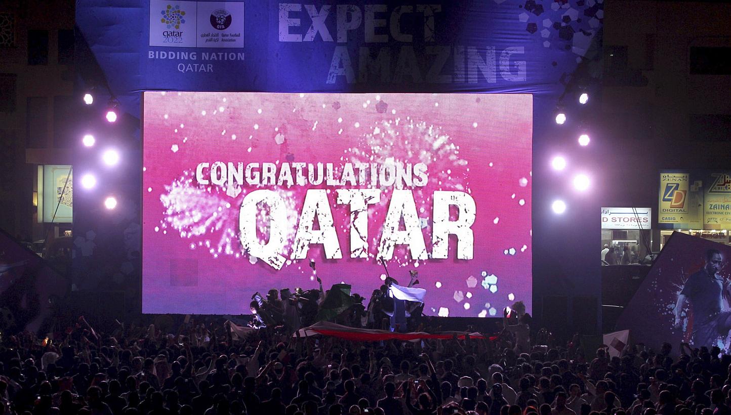 People celebrate in front of a screen that reads "Congratulations Qatar" after Fifa announced that Qatar will be host of the 2022 World Cup in Souq Waqif in Doha in this Dec 2, 2010 file photo. Fifa on Wednesday banned former vice-president Reynald T