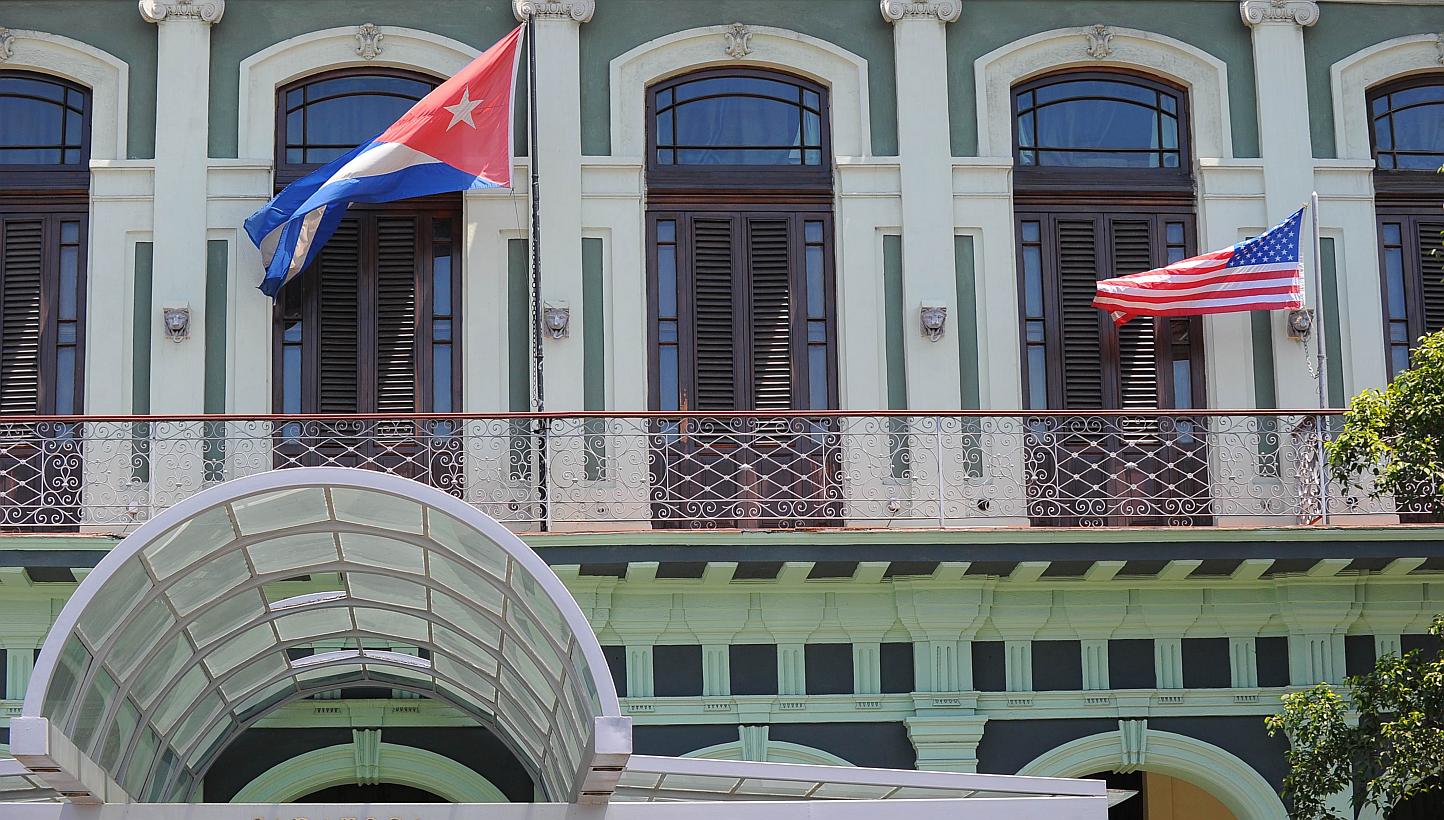 A Cuban and US flag on the balcony of a hotel in Havana on April 13, 2015. US and Cuban negotiators will meet next week to discuss the reopening of embassies in each other's capitals as part of efforts to restore diplomatic ties. -- PHOTO: AFP