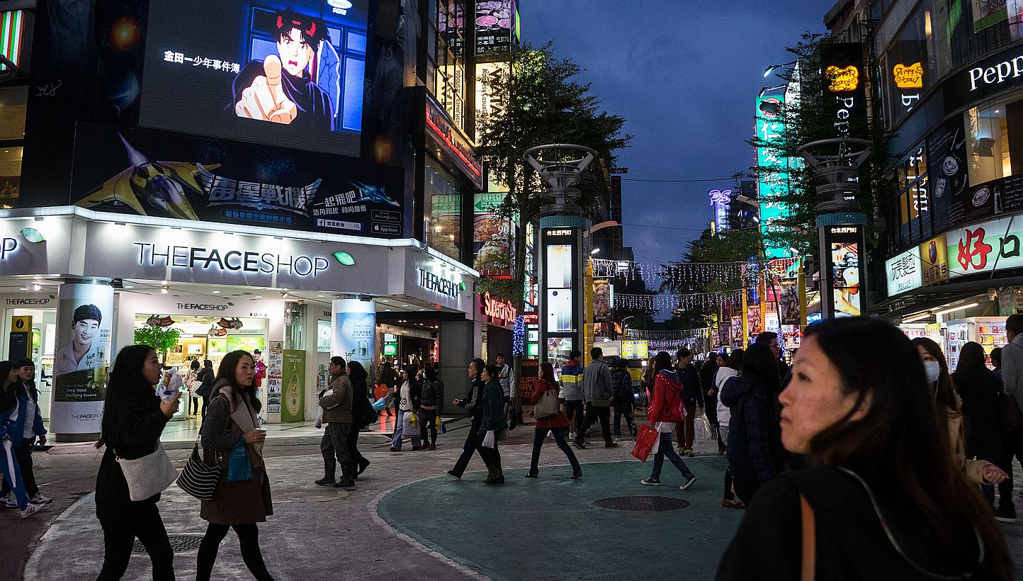 Pedestrians in the shopping district of Ximending in Taipei, on Dec 8, 2014. Taiwan on Friday began enforcing stricter rules on inspecting imported Japanese food products potentially originating in radiation-exposed areas, prompting a warning from To