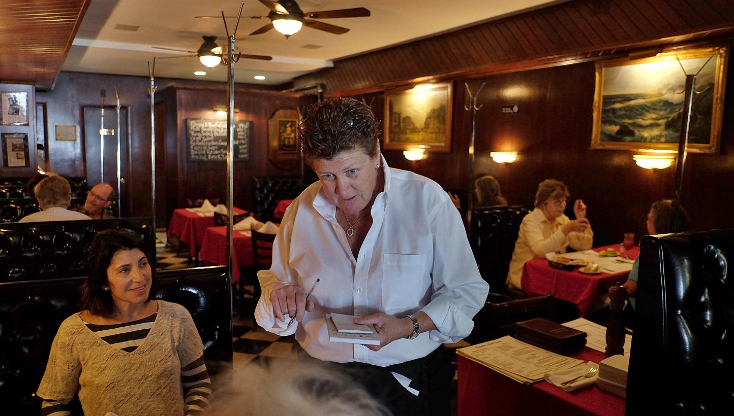 Maureen Donohue-Peters, a waitress at Donohue's Steak House, works in the restaurant in New York on May 14, 2014.&nbsp;Robert Ellsworth, an art collector and a regular to the restaurant who died at the age of 85 in August, left US$100,000 in his will