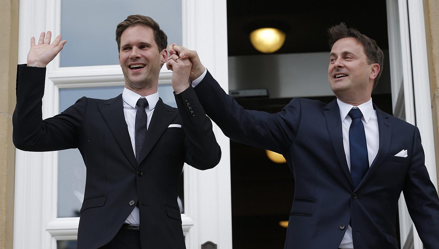 Luxembourg's Prime Minister Xavier Bettel (right) and Gauthier Destenay (left) pose for a photo after they got married in Luxembourg, on May 15, 2015. Bettel is reported to be the EU's first serving leader to marry someone of the same sex. -- PHOTO: 
