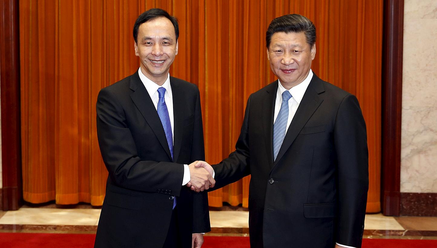 Chairman of Taiwan's ruling Nationalist Kuomintang Party (KMT) Eric Chu, also New Taipei mayor, shakes hands with China's President Xi Jinping as they pose for pictures during their meeting in Beijing, China on May 4, 2015. -- PHOTO: REUTERS