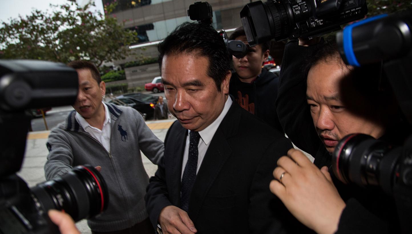 Carson Yeung, owner of Birmingham City Football Club and former chairman of Birmingham International Holdings Ltd., is surrounded by members of the media as he enters the Wanchai Law Courts in Hong Kong, China, on Friday, Feb. 28, 2014. -- PHOTO: ST 