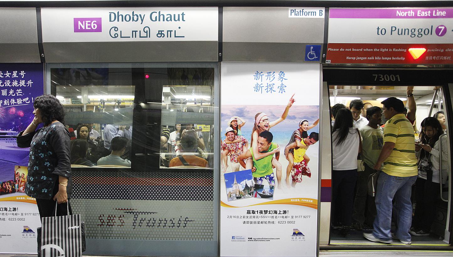Commuters getting into a train at Dhoby Ghaut MRT station on the North-East Line (NEL). New trains on both the NEL and the Circle Line will be fitted with gap fillers. -- PHOTO: ST FILE