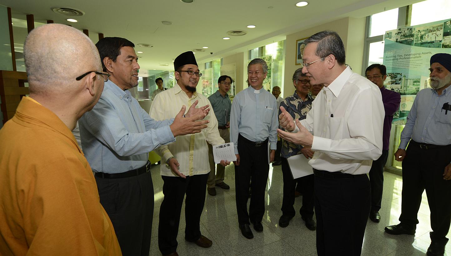 Minister of State for Culture, Community and Youth, Mr Sam Tan Chin Siong (centre with spectacles), at the Building Bridges seminar held on May 16,2015 by the Harmony Centre of Muis and the Singapore Buddhist Federation. -- PHOTO: MUIS 
