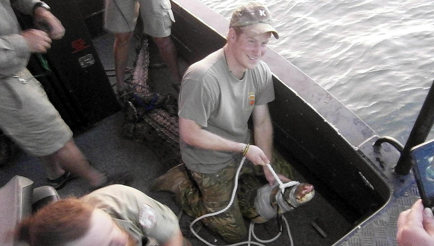 A photo made available by the Government of the Northern Territory on May 16, 2015, shows Britain's Prince Harry (centre) during an operation with Northern Territory Wildlife Rangers to capture and remove a saltwater crocodile in Darwin Harbour. -- P