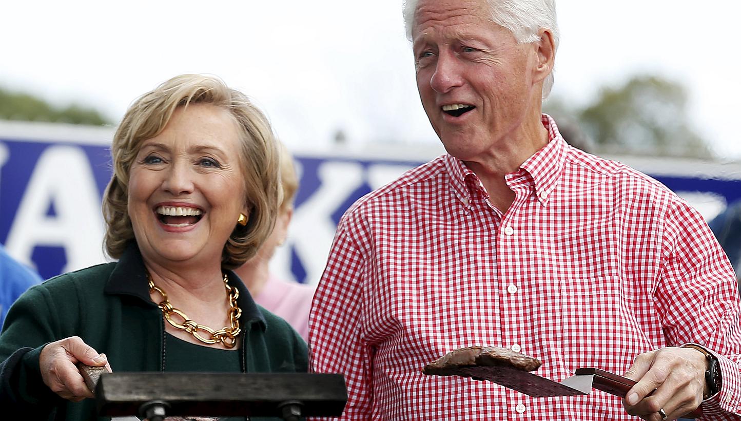 Former US Secretary of State Hillary Clinton and her husband former US President Bill Clinton holding up some steaks at the 37th Harkin Steak Fry in Indianola, Iowa, in this Sept 14, 2014 file photo. The Clintons earned at least US$30 million (S$40 m
