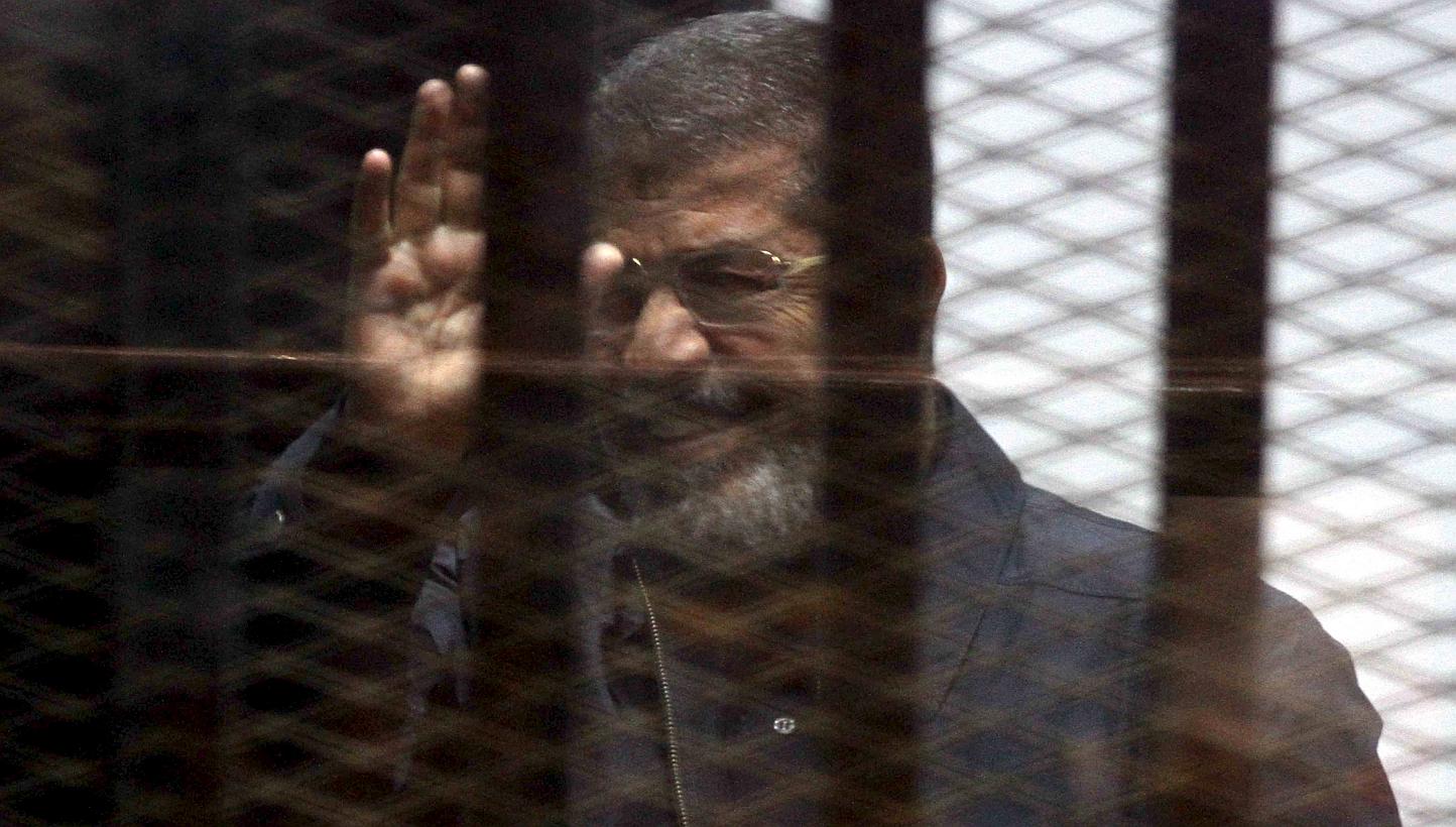 Ousted Egyptian president Mohamed Mursi is seen behind bars during his trial at a court in Cairo on April 30, 2015. -- PHOTO: REUTERS