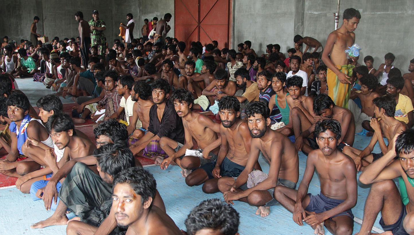 A group of rescued migrants at a confinement area in the fishing town of Kuala Langsa in Aceh province yesterday. More than 700 Rohingya and Bangladeshi migrants arrived in Indonesia yesterday after they were rescued by fishing boats when their vesse