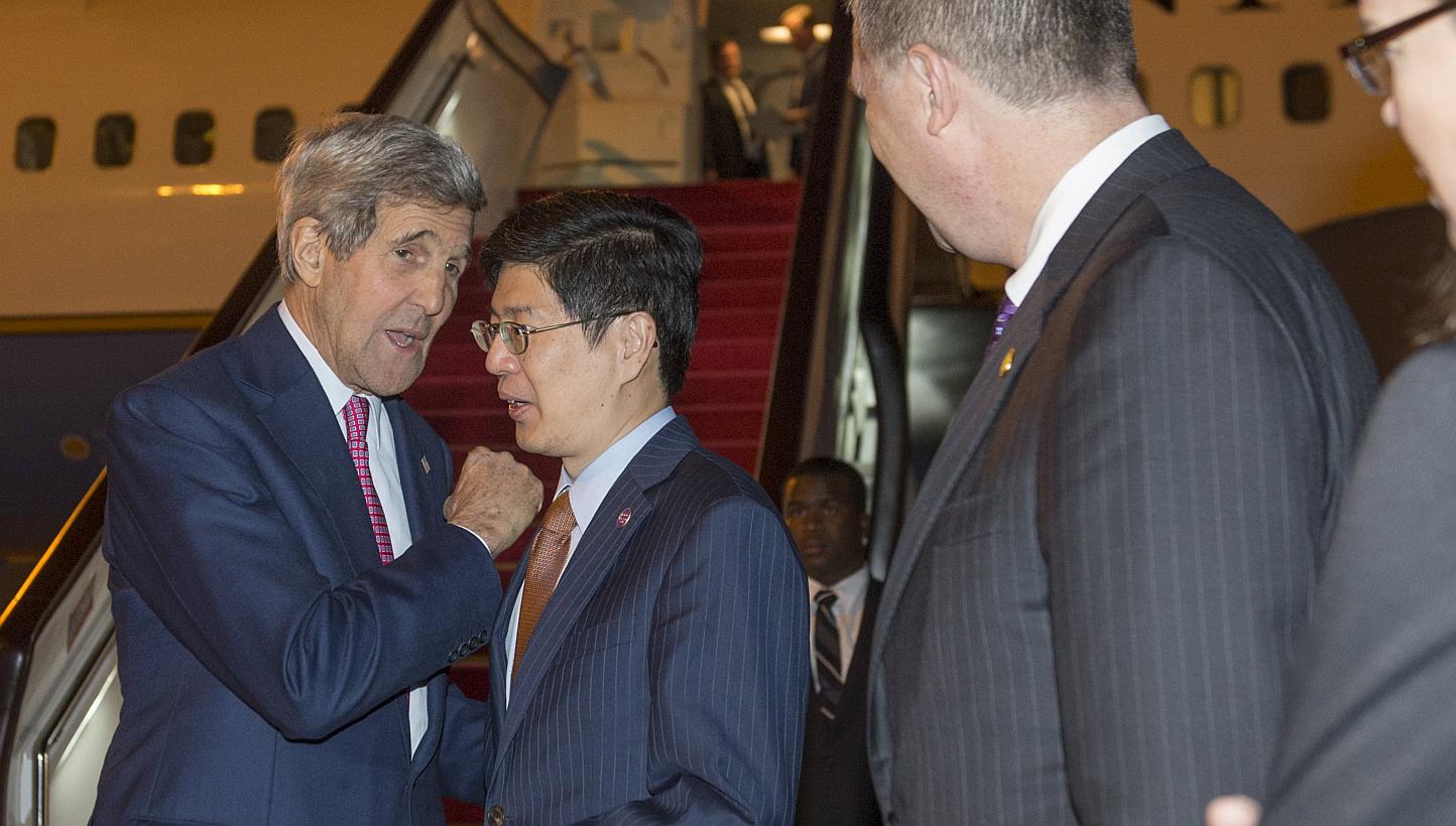 US Secretary of State John Kerry (left) speaking with Chinese Ministry of Foreign Affairs Director General Cong Peiwu as he disembarks from his plane upon arrival in Beijing on May 16, 2015. -- PHOTO: REUTERS