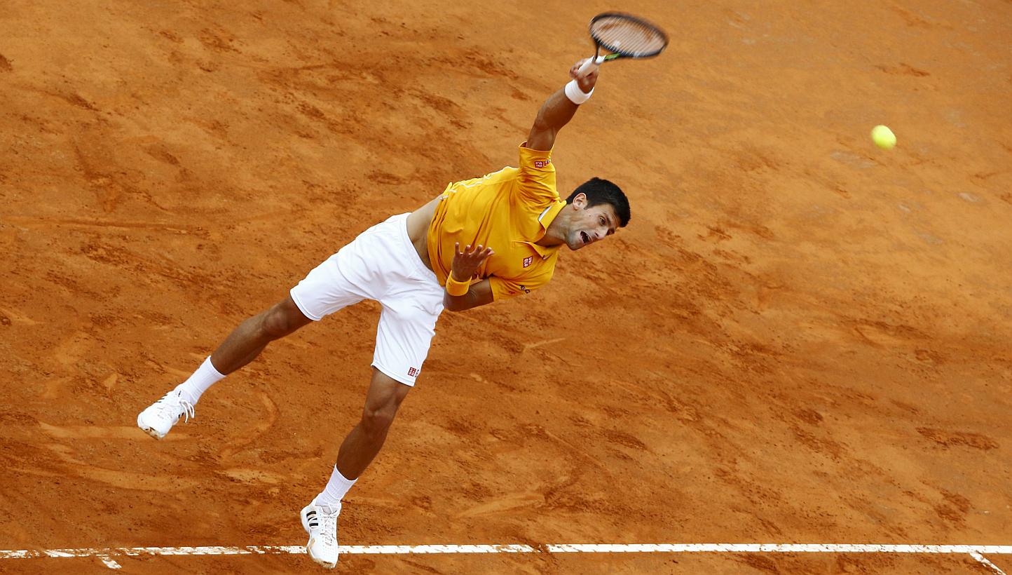 Novak Djokovic of Serbia serves to Kei Nishikori of Japan during their match at the Italian Open tennis tournament in Rome, Italy, May 15, 2015. -- PHOTO: REUTERS