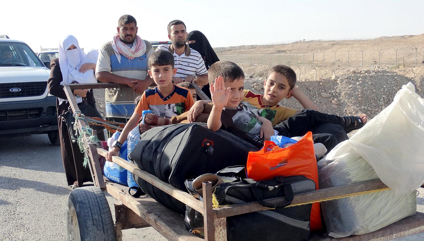 Sunni people react as they flee the violence in the city of Ramadi. Islamic State militants raised their black flag over the local government headquarters on May 15, 2015 and claimed victory through mosque loudspeakers after overrunning most of the w