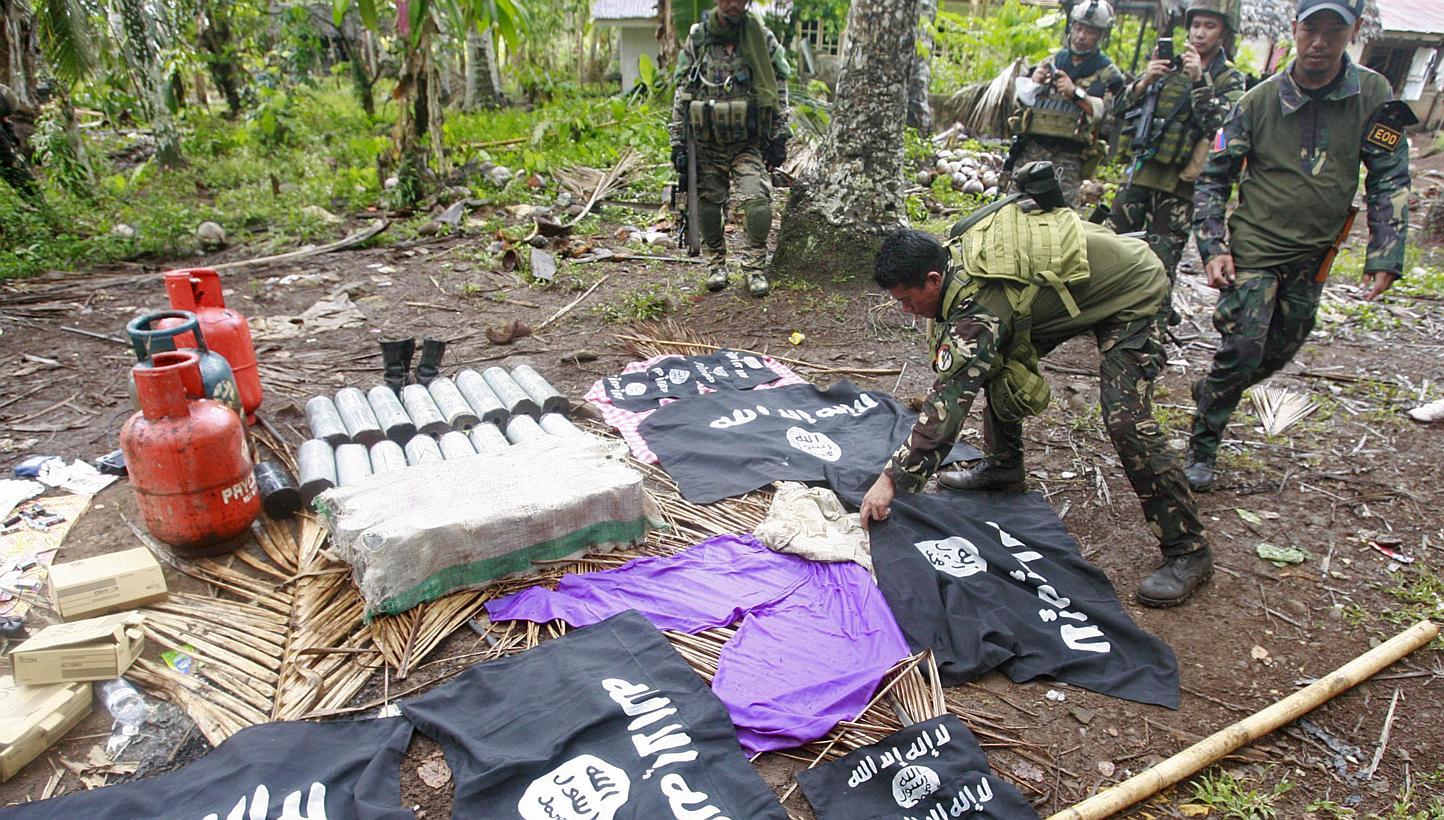 Philippine soldiers display various types of seized improvised explosive devices with related material and 'shahada' banners similar to those used by ISIS, at a village in Mohammad Ajul town, Basilan province in southern island of Mindanao on May 16,