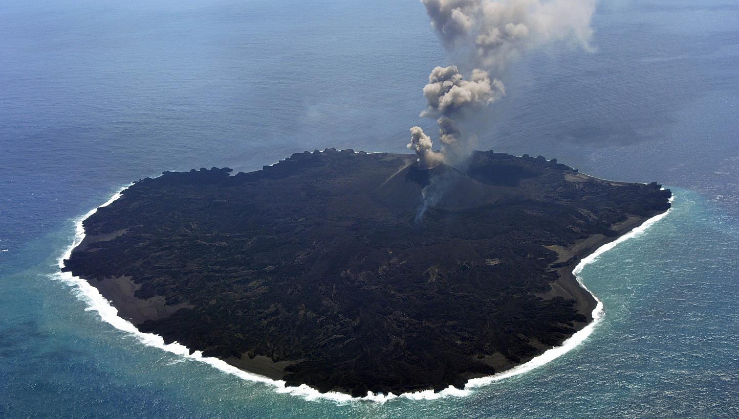 This handout picture taken by Japan Coast Guard on March 25, 2015 shows the newly created Nishinoshima island at the Ogasawara island chain, 1,000 kilometres south of Tokyo. A brand new island emerging off the coast of Japan offers scientists a rare 