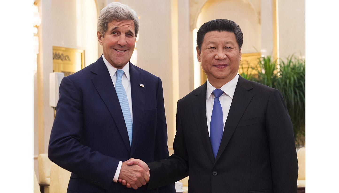 Chinese President Xi Jinping and US Secretary of State John Kerry shake hands prior to holding a meeting at the Great Hall of the People in Beijing, China on May 17, 2015. China's ties with the United States remain stable, Mr Xi said on Sunday,