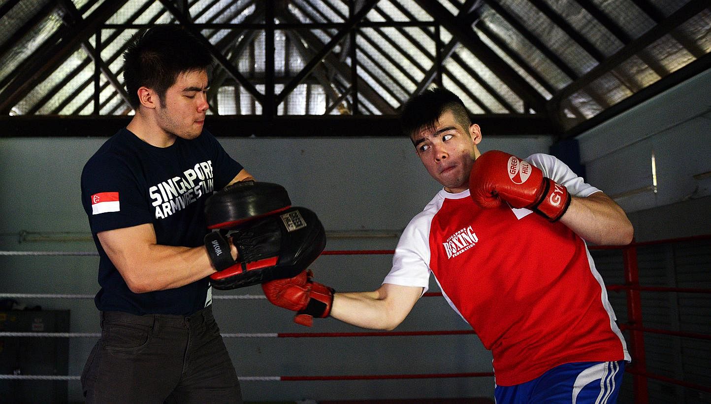 Tay Jia Wei (right), practising with his biggest supporter - his twin brother Jia Jun - took up boxing in a bid to stand up to bullies who teased him over his weight of 80kg when he was 14.