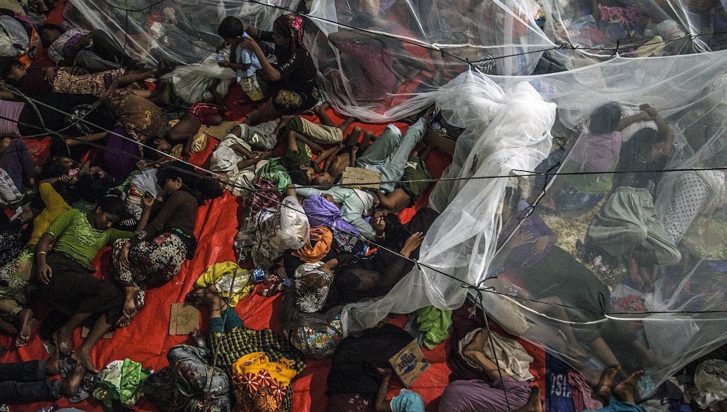Rohingya migrants sleeping at the new confinement area in the fishing town of Kuala Langsa in Aceh province on May 16, 2015 where hundreds of migrants from Myanmar and Bangladesh mostly Rohingyas are taking shelter after they were rescued by Indonesi