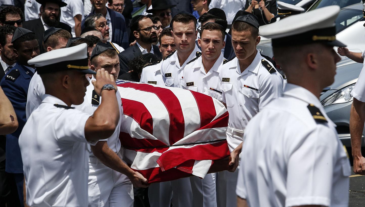 Midshipmen from the US Naval academy carry Midshipman Justin Zemser to a waiting car after his funeral on May 15, 2015 in Hewlett, New York. Zemser was one of eight people killed in the derailment of an Amtrak train on May 12th in Philadelphia. -- PH