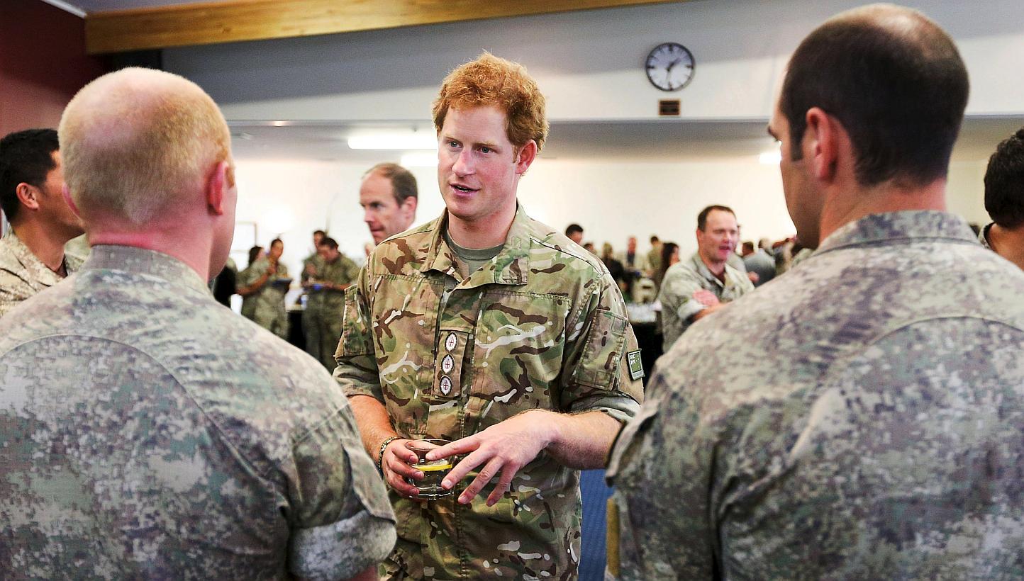 Britain's Prince Harry speaks to military personnel during his visit to Linton Military Camp near Palmerston North, on May 13, 2015.&nbsp;The British Royal called for the return of national service in his home country, crediting a military career for