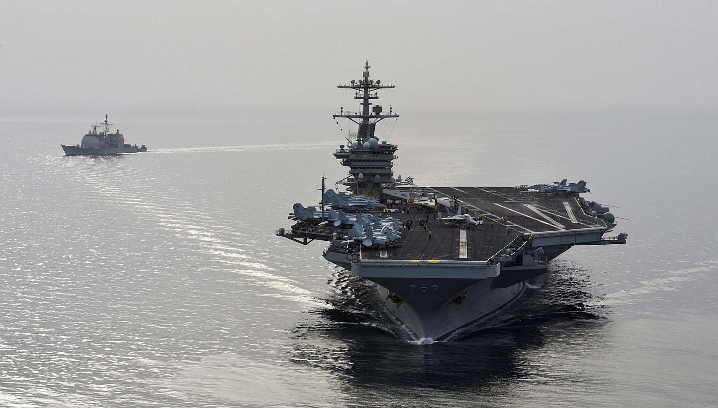 American aircraft carrier USS Theodore Roosevelt and guided-missile cruiser USS Normandy sail in the Gulf on April 16, 2015, supporting strike operations in Iraq and Syria as directed.&nbsp;At least 32 Islamic State in Iraq and Syria (ISIS) members, 
