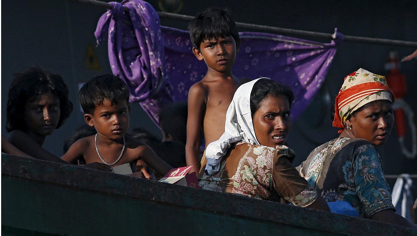 Migrants looking on while on board a boat tethered to a Thai navy vessel, in waters near Koh Lipe island, on May 16, 2015.&nbsp;Muslim boatpeople fleeing dire conditions in Myanmar are entitled to "human rights", a spokesman for Aung San Suu Kyi's op