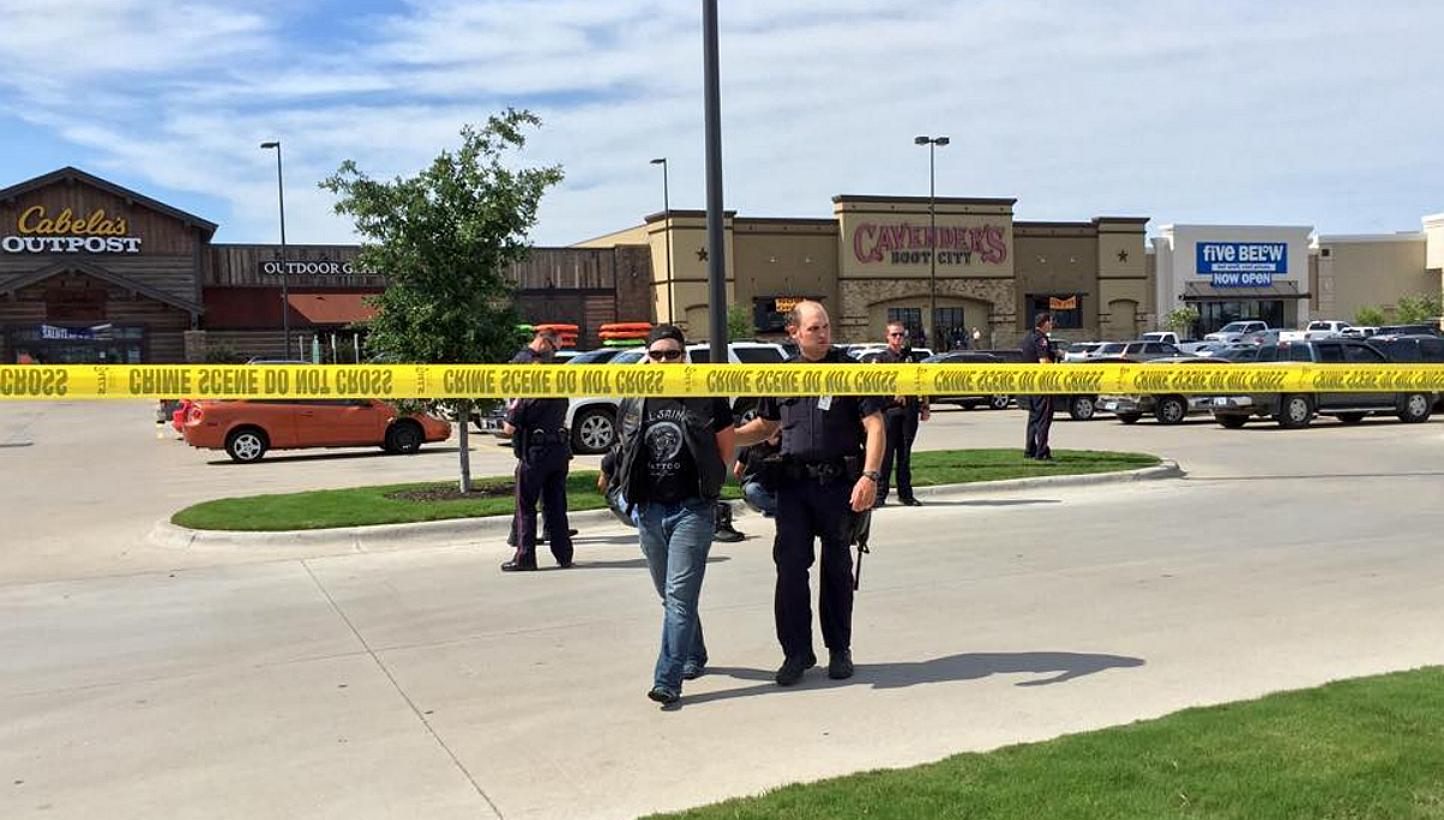 Police escort a man at the scene of a shooting in Waco, Texas, in this handout photo provided by the Waco Police Department on May 17, 2015. Police in Waco, Texas said on Monday, May 18, that 192 people were being arrested in connection wi